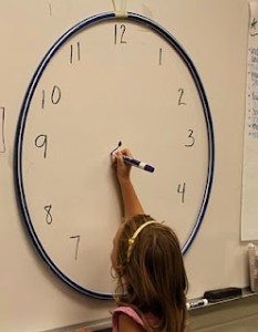 Use a hoola-hoop to create a big class clock.